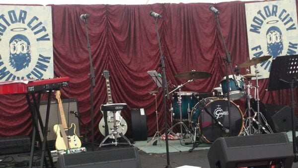 stage setup for a hire a band including band backline, Gretsch Maple Renown Drum Kit, microphones, foldbacks and drapes