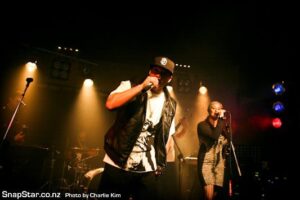This photo shows Young Sid (now known as Sidney Daimond) playing onstage at The Juice Bar in Auckland. On this occasion Sid was playing with a full band. You can see backing vocalist Gail in the background and lighting + sound by The Rock Factory in Auckland.Sid sometimes plays with DJ hire Auckland, but on this occasion, he played with band members from Halo. Photo taken by Charlie Kim.
