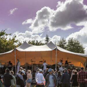 Stretch Tent Covered Stage - Large Outdoor Covered Stage perfect for community events. An example of stage hire auckland and marquee hire auckland. The stretch tent marquee make a great cover for a stage on grass and is popular with fia fia and kapa haka cultural events as well as for band stages.