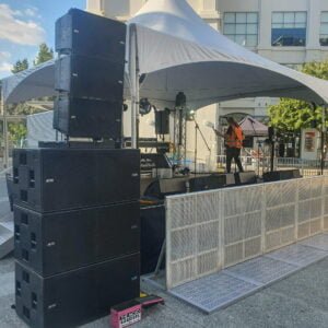A ground-stacked outdoor sound system, set up at an outdoor event. The Rock Factory specialise in live sound hire and event production.