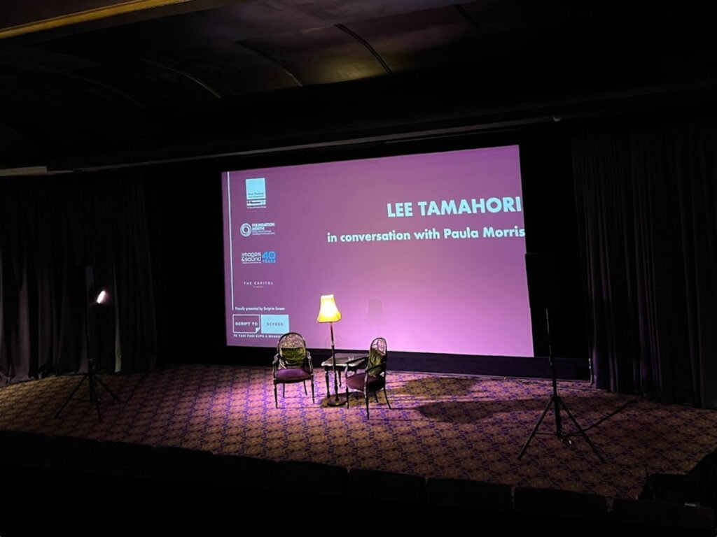 Workshop or conference set-up, with projector and screen, and audio equipment.