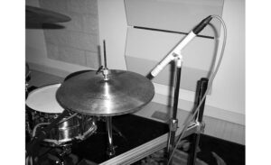Shure sm81 small diaphragm condenser microphone positioned over a hihat. hire sm81 as a drum overhead today!