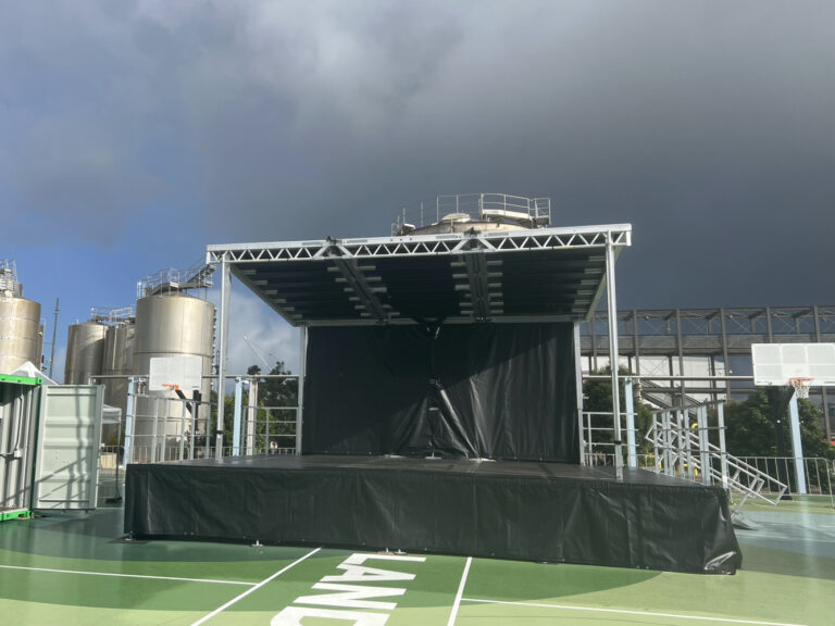 The Stageline SL75 Mobile Trailer Stage available for hire in Auckland from The Rock Factory. In this photo the stage is setup at Silo Park. The standard size is 6 by 5m but this one is extended 1 metre on each side and 1 metre forward do that it is 8 by 6m.