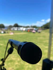 Picture of a Shure Nexodyne Microphone being used a Music in Parks summer 2025.