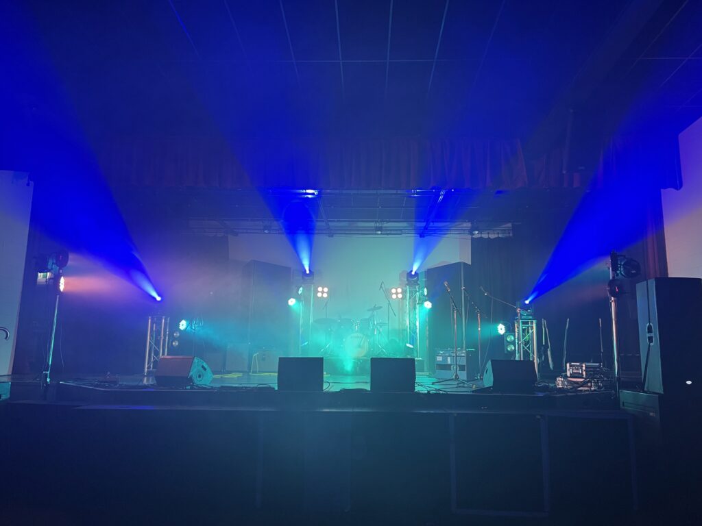 Photo of an example touring PA and lighting rig for a touring band or musician. The Rock Factory can help you with nationwide tour production sp you get a consistent result at every venue. PA System hire options.
