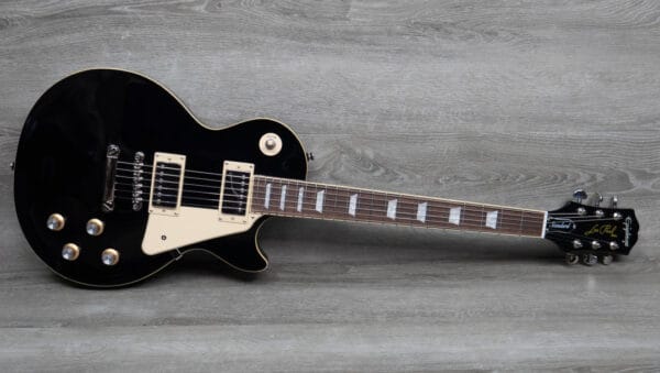 A close-up shot of a sunburst Epiphone Les Paul guitar, highlighting its iconic shape and humbucker pickups.